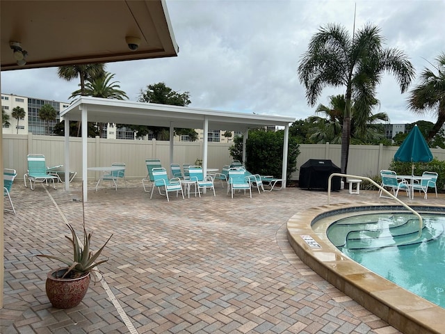 view of pool featuring a patio area and area for grilling