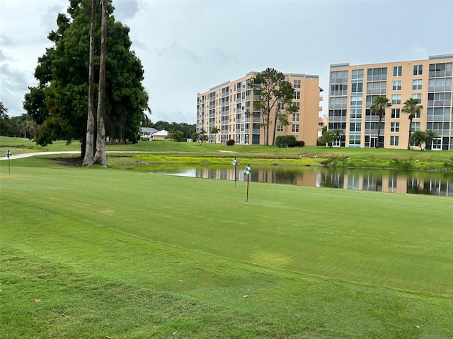 surrounding community featuring a lawn and a water view