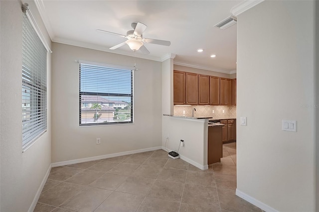 kitchen with ceiling fan, decorative backsplash, light tile patterned floors, and ornamental molding