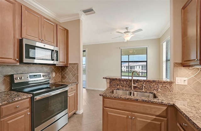 kitchen featuring appliances with stainless steel finishes, tasteful backsplash, ornamental molding, sink, and light tile patterned floors