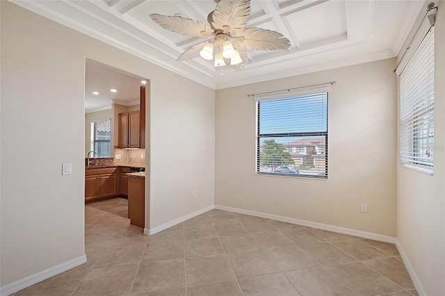 tiled spare room with crown molding, sink, ceiling fan, and coffered ceiling