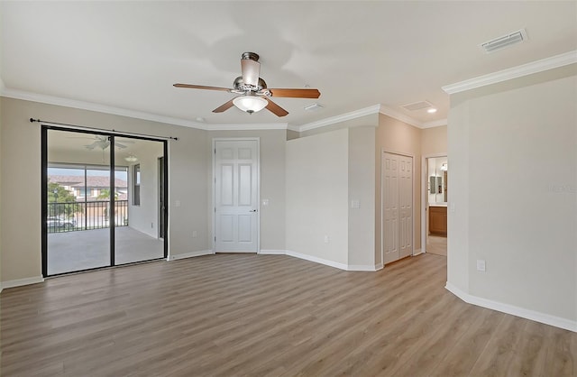 spare room featuring light wood-type flooring, ceiling fan, and ornamental molding