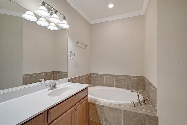 bathroom with vanity, ornamental molding, and tiled tub