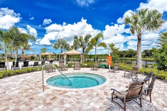 view of swimming pool featuring a gazebo and a hot tub