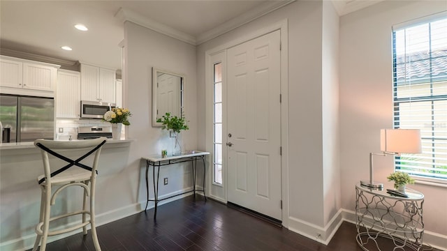 entryway featuring dark hardwood / wood-style floors and ornamental molding