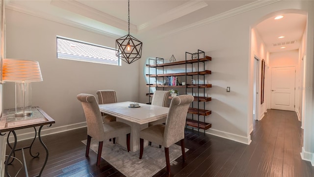 dining area featuring ornamental molding and dark wood-type flooring