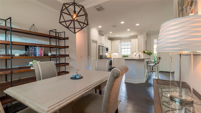 dining room with dark wood-type flooring and ornamental molding