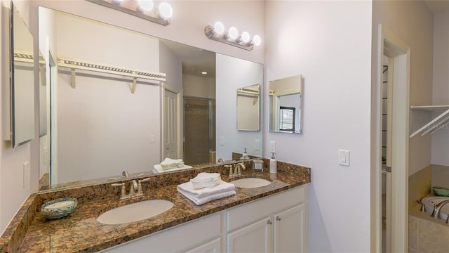 bathroom with a bath and vanity