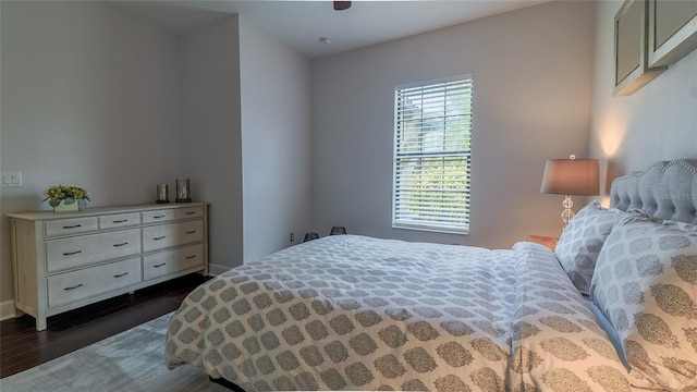 bedroom with ceiling fan and dark hardwood / wood-style flooring