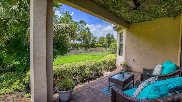 view of patio / terrace featuring an outdoor hangout area, a fenced backyard, and a ceiling fan