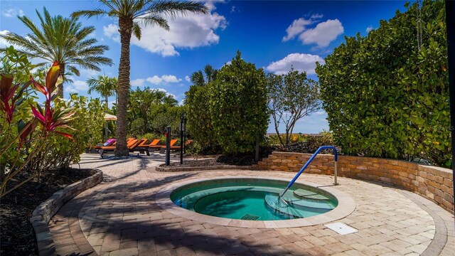 view of pool featuring an in ground hot tub and a patio area