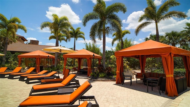 view of home's community featuring a patio area, an outdoor living space, and a gazebo