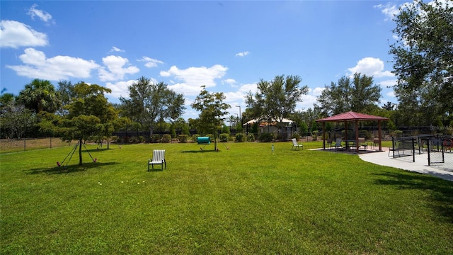 view of property's community with a lawn and a gazebo