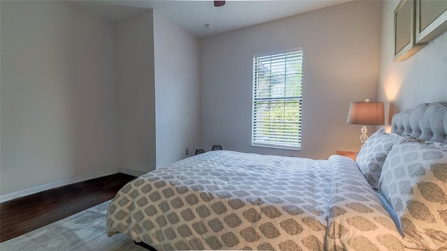 bedroom with ceiling fan and dark wood-type flooring