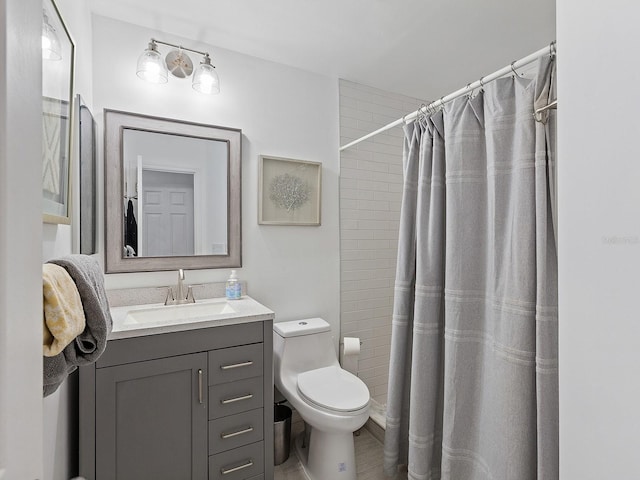 bathroom with toilet, vanity, and a shower with shower curtain