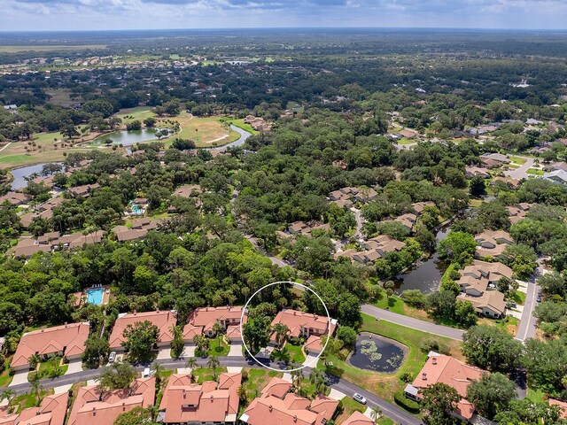 birds eye view of property featuring a water view and a residential view