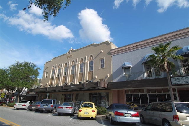 view of building exterior with uncovered parking