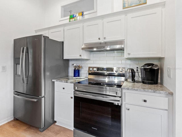 kitchen featuring tasteful backsplash, appliances with stainless steel finishes, light wood-style floors, white cabinetry, and under cabinet range hood