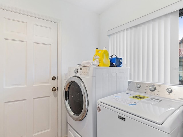 laundry area with separate washer and dryer