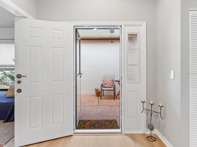 foyer entrance with light wood-type flooring and baseboards