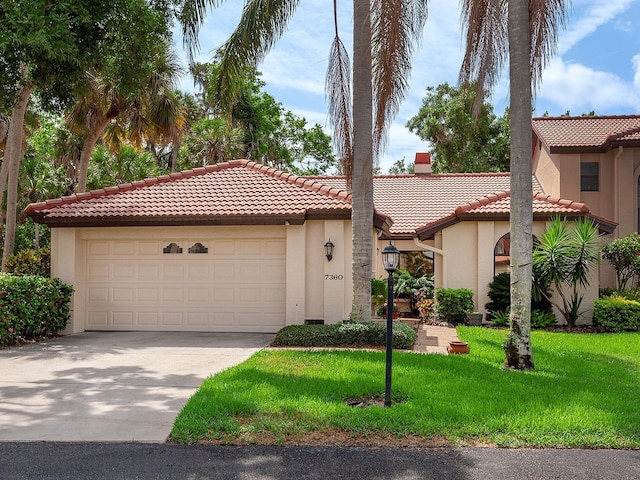 mediterranean / spanish-style house featuring a tiled roof, a chimney, a front lawn, and stucco siding