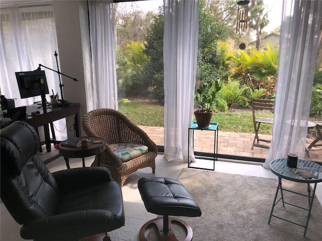 interior space featuring a wealth of natural light and light carpet