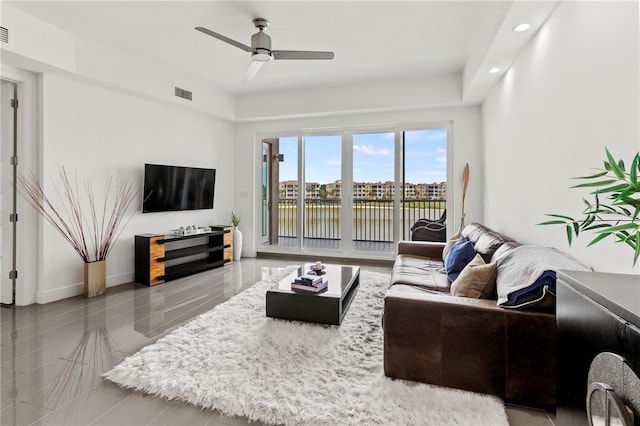 living room featuring light tile patterned flooring and ceiling fan