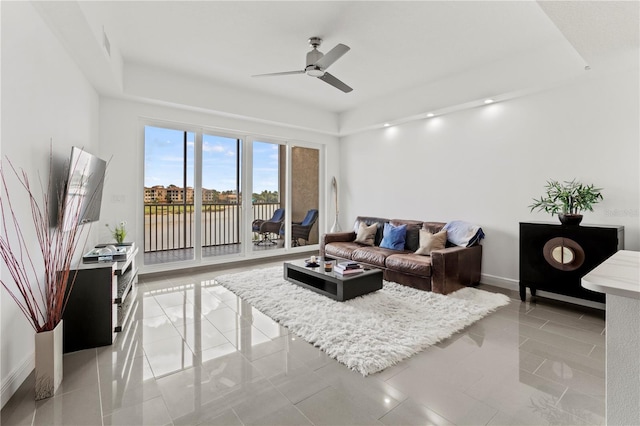 living room featuring light tile patterned flooring and ceiling fan