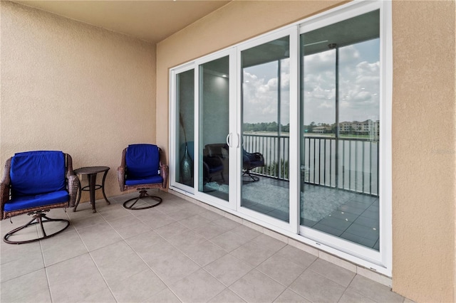 balcony with a patio area and a water view