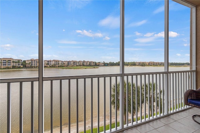 unfurnished sunroom with a wealth of natural light and a water view