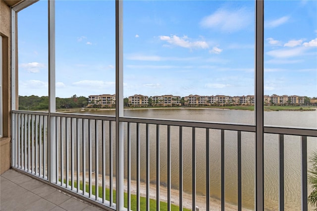 unfurnished sunroom featuring a water view