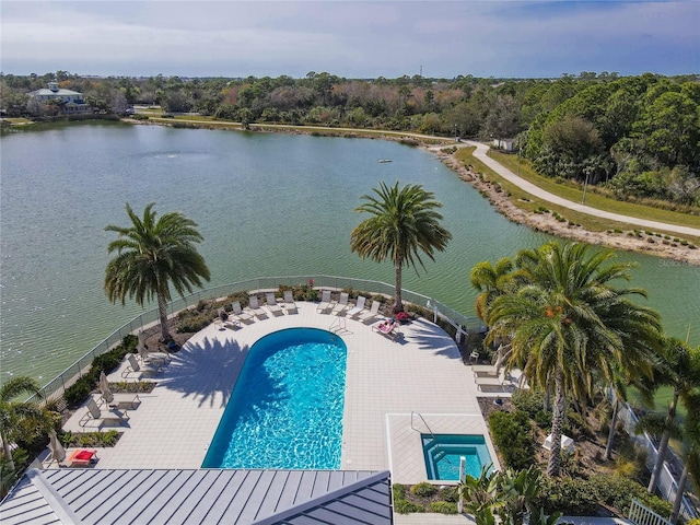 view of swimming pool featuring a water view and a patio area