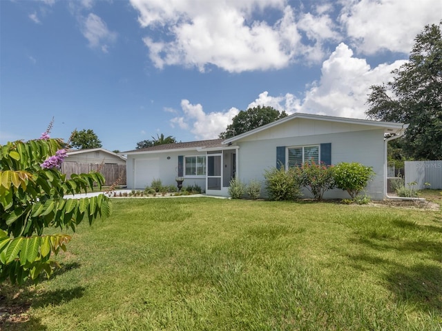 back of house featuring a yard and a garage