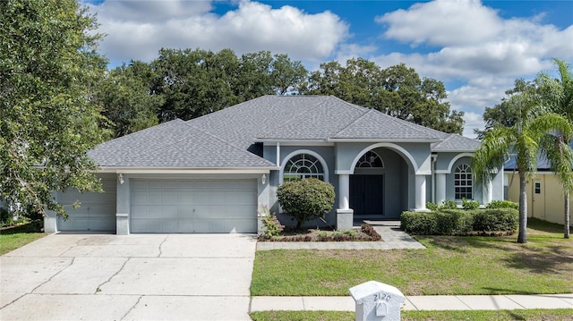 view of front of home featuring a front yard and a garage