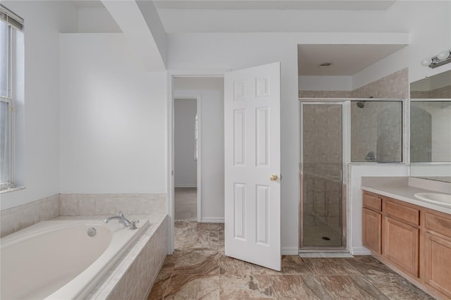 bathroom featuring vanity and shower with separate bathtub