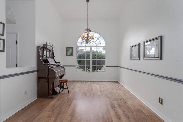 interior space with a chandelier and wood-type flooring