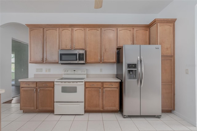 kitchen with ceiling fan, light tile patterned flooring, and stainless steel appliances