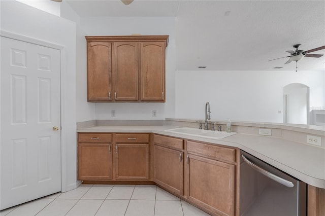 kitchen with ceiling fan, sink, stainless steel dishwasher, kitchen peninsula, and light tile patterned floors