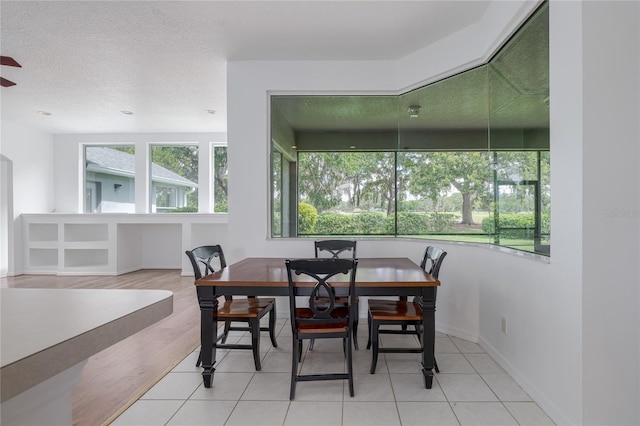 dining area with a textured ceiling and hardwood / wood-style flooring