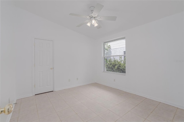 tiled spare room with vaulted ceiling and ceiling fan