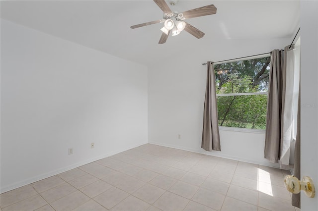 tiled spare room with vaulted ceiling and ceiling fan