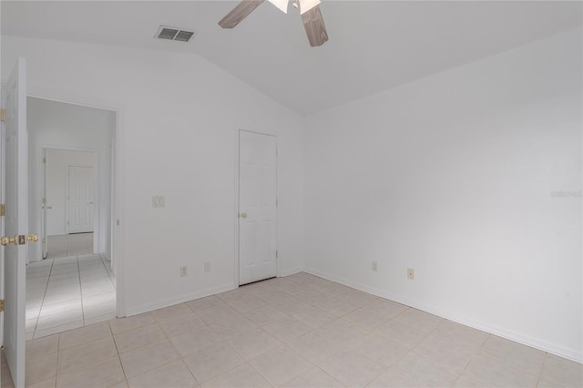 tiled spare room featuring ceiling fan and vaulted ceiling