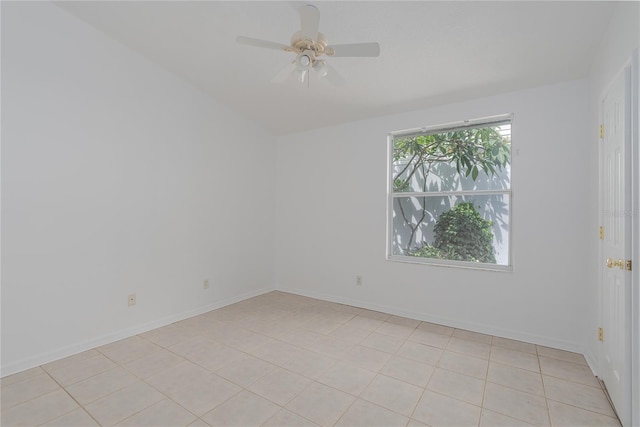 tiled spare room featuring ceiling fan