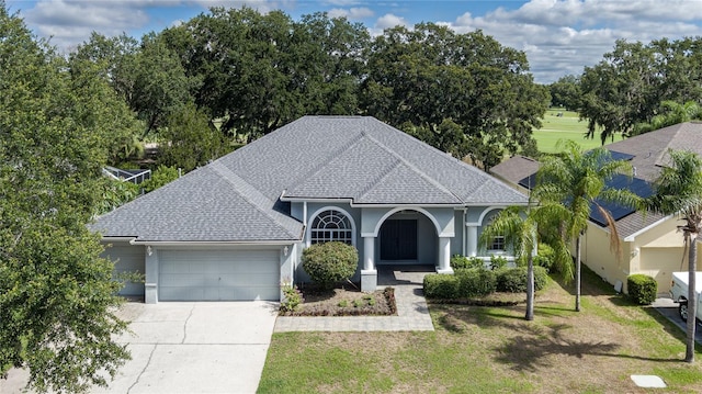 view of front of property featuring a front yard and a garage