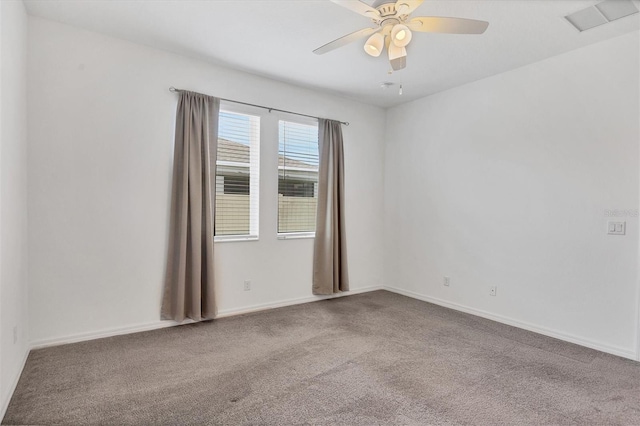 carpeted spare room with ceiling fan