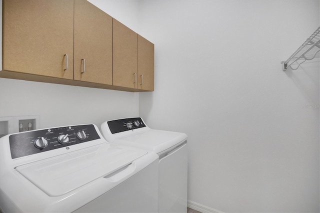 laundry area with cabinets and washing machine and dryer