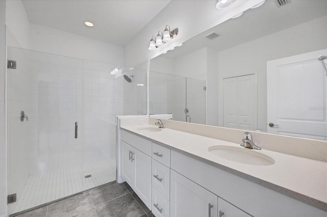 bathroom featuring tile patterned floors, vanity, and walk in shower