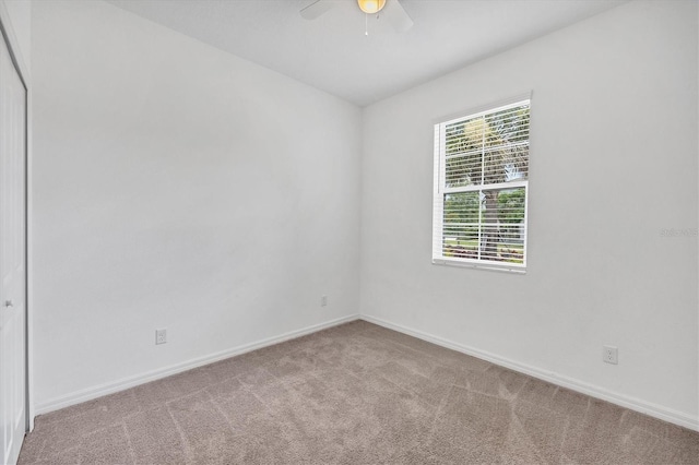 unfurnished room with ceiling fan and light carpet