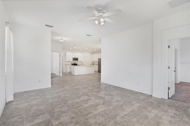 unfurnished living room with ceiling fan