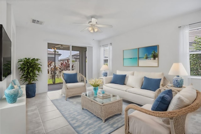 tiled living room with ceiling fan